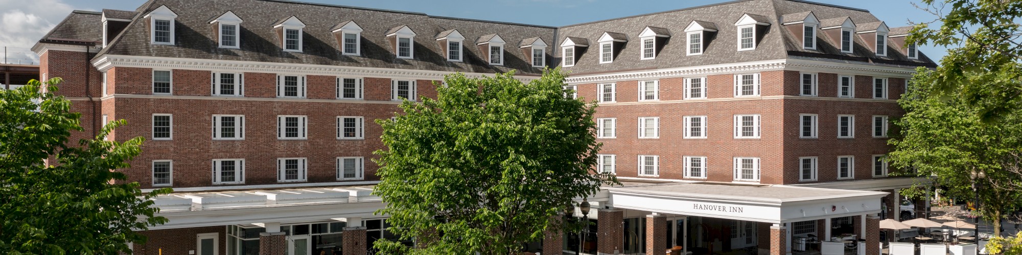 A large brick building with multiple windows, labeled 