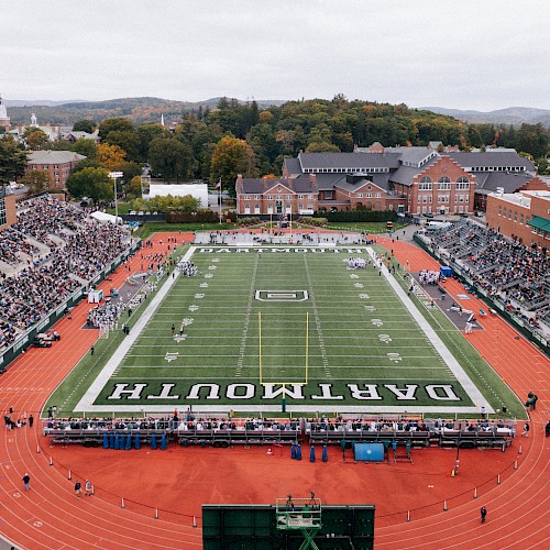 Aerial view of a football stadium with a track, marked 