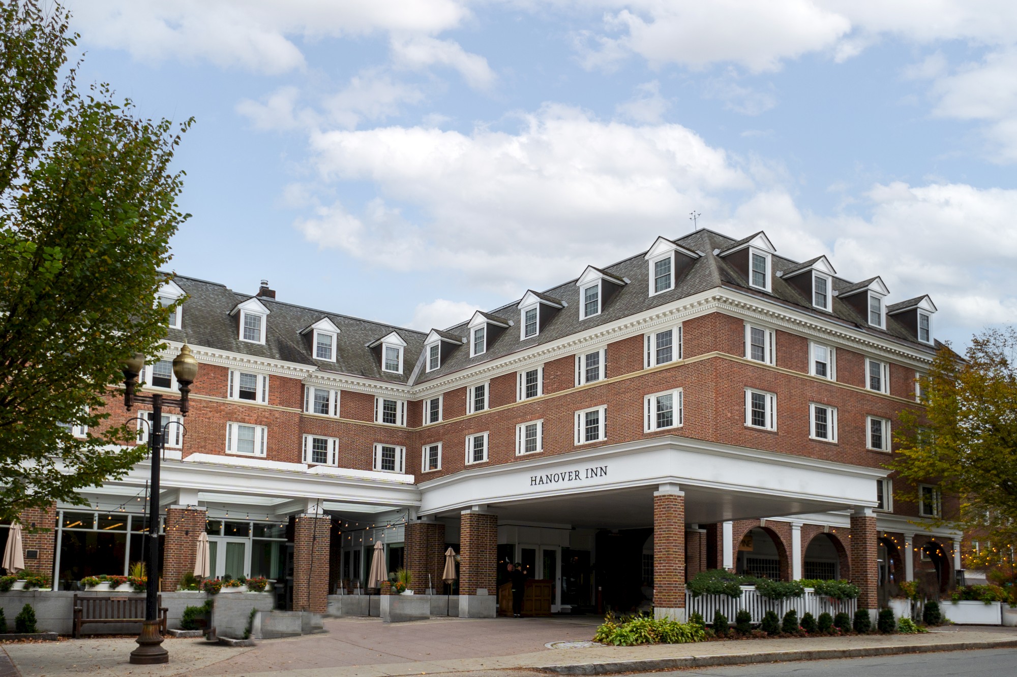A multi-story brick building with numerous windows and an arched entryway labeled 
