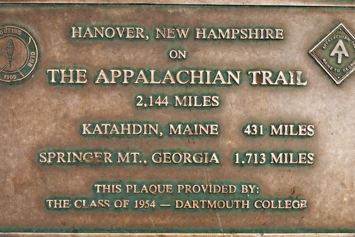 Plaque marking Hanover, NH on the Appalachian Trail, provided by Dartmouth College's Class of 1954, with distances to endpoints.