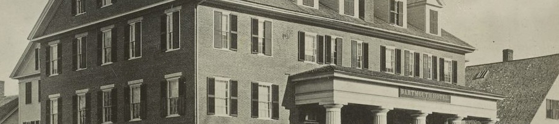 The image shows a historic three-story building with columns and dormer windows, labeled as Dartmouth College.