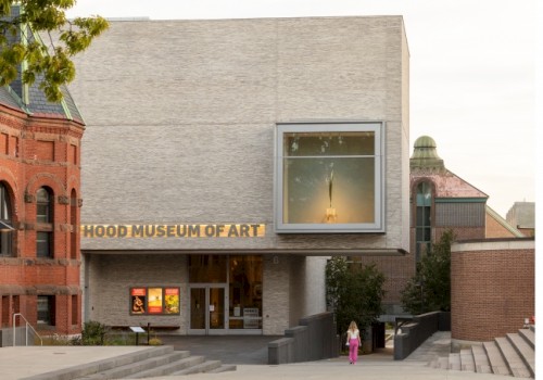 The image shows the entrance of the Hood Museum of Art, featuring contemporary architecture and a display window.