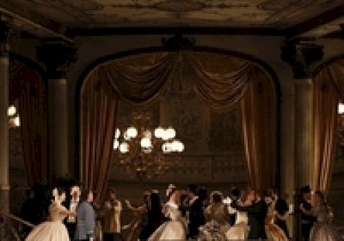 An elegant ballroom scene with people in 19th-century attire dancing under ornate chandeliers, surrounded by lavish drapery and decor.